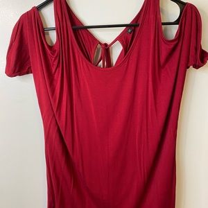 Red short sleeve shirt. Open shoulders.